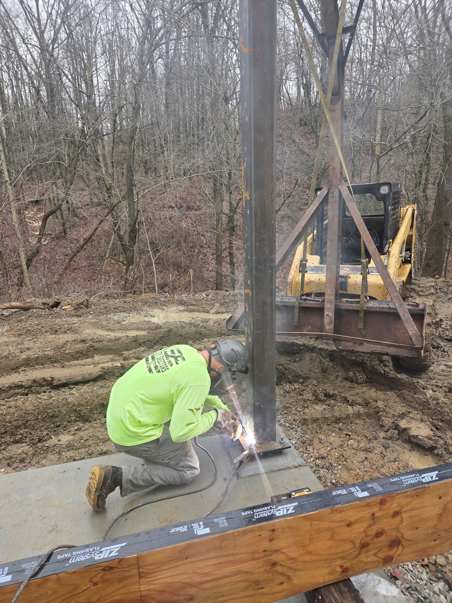 Technician performing on-site mobile welding and fence repair work
